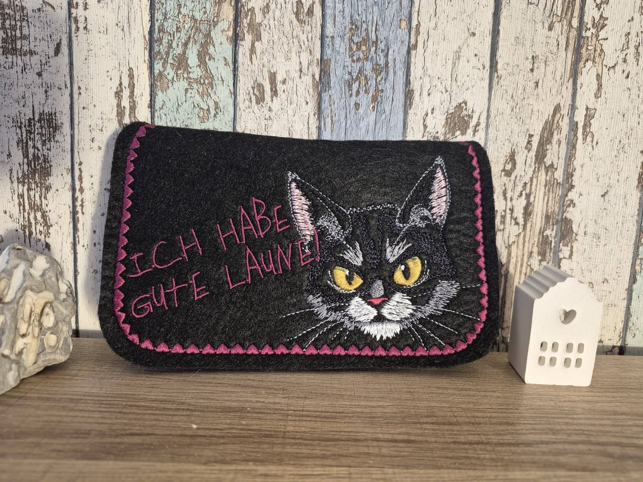 Grumpy cat embroidered on dark fabric